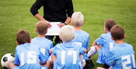 Children Soccer Coach Explaining Tactics To Kids Football Team