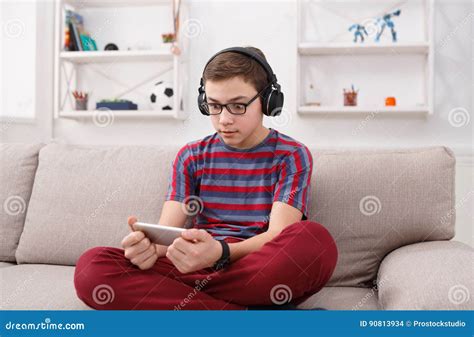 Excited Teenage Boy Playing Mobile Game At Home Stock Photo Image Of