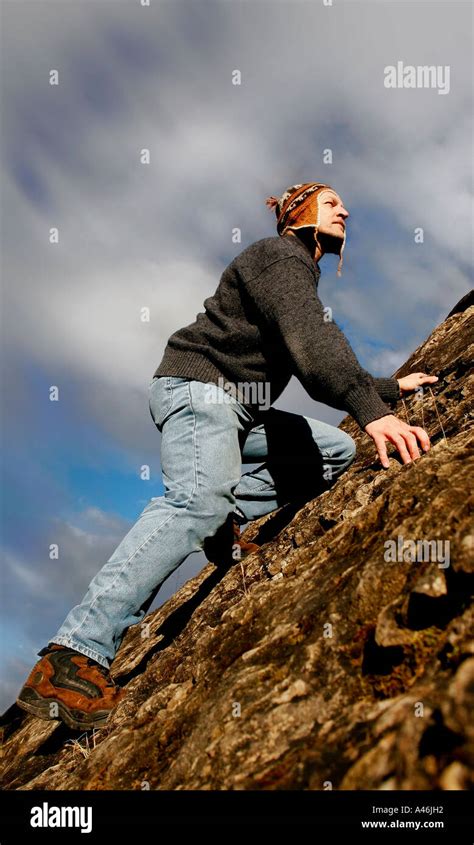 Man Climbing Steep Slope Stock Photo Alamy