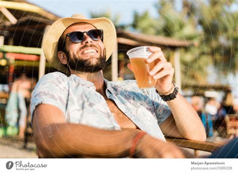 Young Handsome Man Enjoying Beer In Beach Bar A Royalty Free Stock