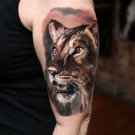 Realistic Style Lioness Tattoo On The Left Upper Arm