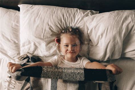 Portrait Of Cute Adorable Smiling Little Girl Waking Up And Stretching