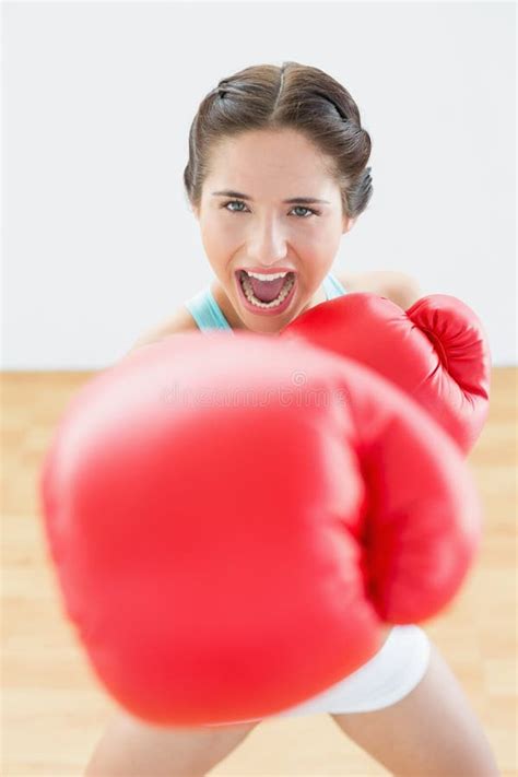 Beautiful Young Woman In Red Boxing Gloves At Fitness Studio Stock