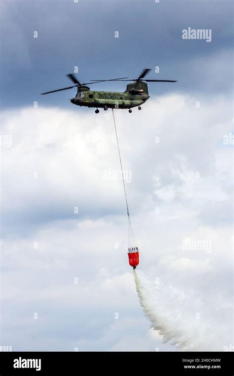 Boeing Ch 47 Chinook Helicopter Dropping Water From A Water Bucket