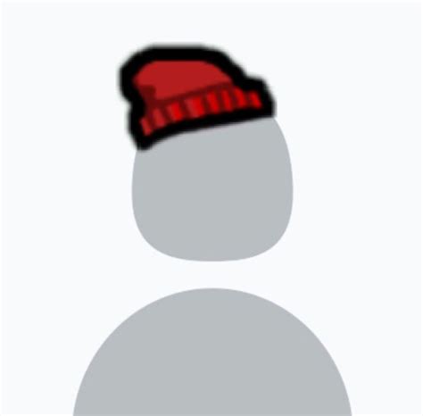 A Snowman With A Red Hat On Its Head