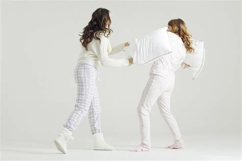 premium photo girl fight pillows pajama party