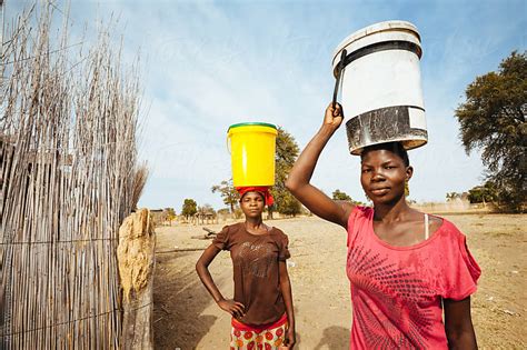 Young African Hambukushu Women Carrying Water By Micky Wiswedel