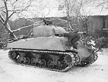 [Photo] Sgt Dee Perry of the 10th Armored Division applying winter ...