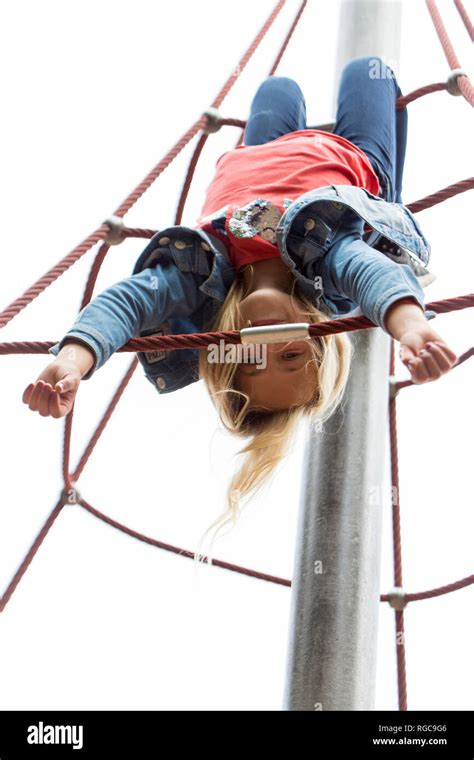 Blond Girl Hanging Upside Down Jungle Gym Playground Hi Res Stock