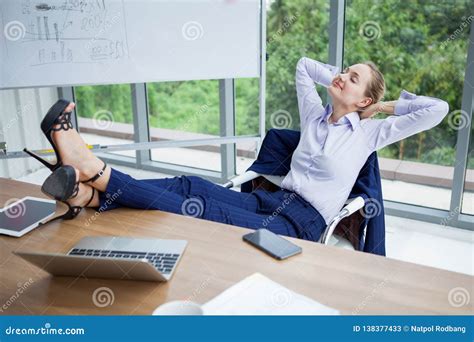 Business Woman Relaxing Or Sleeping With Her Feet On The Desk In Office Female Boss Worker