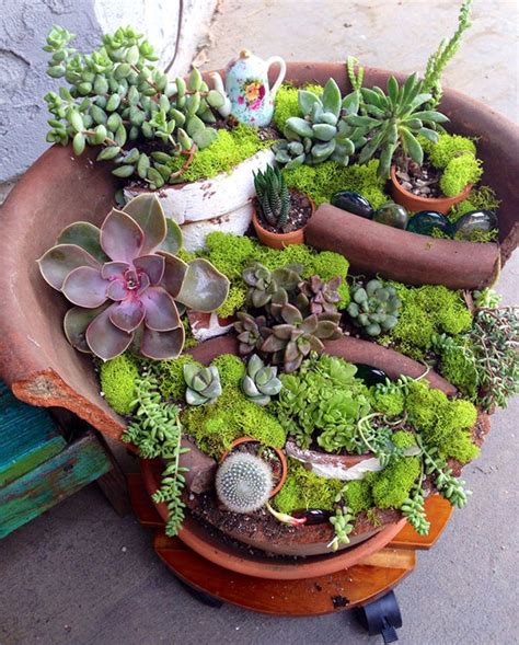 Simple budget friendly fairy garden. DIY Fairy Gardens Made From Broken Pots | DeMilked
