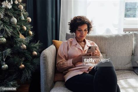 woman holding phone christmas photos and premium high res pictures getty images