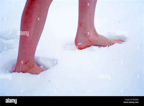 Legs Of A Young Boy Walking Barefoot In Snow Stock Photo Alamy