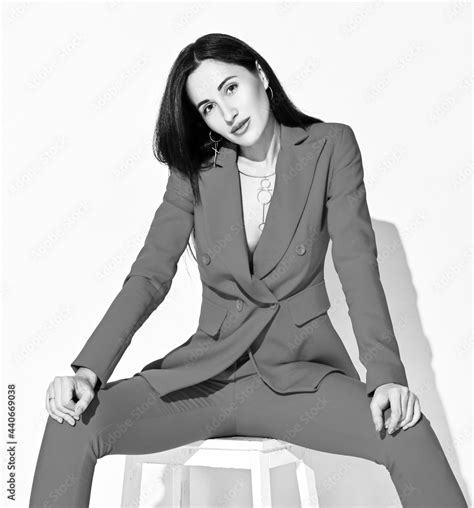 Black And White Portrait Of Young Brunette Woman In Official Pantsuit