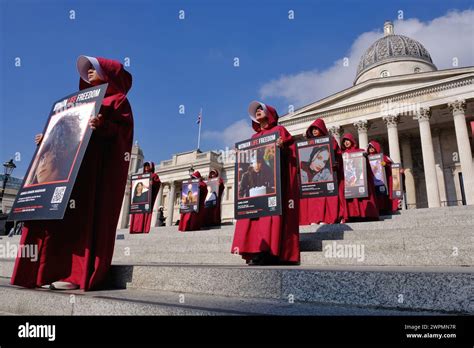 London, UK, 8th March, 2024. British-Iranians dressed in handmaids tale