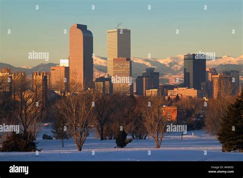 Denver Colorado Skyline At Sunrise With Rocky Mountains In Distance
