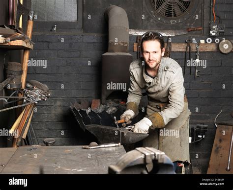 Portrait Of Blacksmith Hammering On Workshop Anvil Stock Photo Alamy