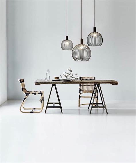 A sculptural light fixture above the dining room table can also make low ceilings appear taller by directing the gaze upwards towards the light fixture rather than at the height of the ceilings. When hanging pendant lights in a row - for example, above ...