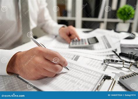 Businessman Working At Office And Calculating Finance Reads And Writes