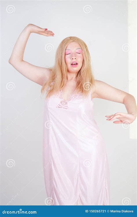 Charming Chubby Blonde Girl In Pink Pretty Nightgown Stretch Hands On