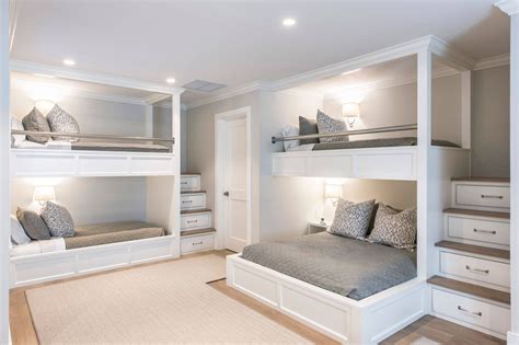 A Bedroom With Bunk Beds And Drawers In The Corner Along With Two Lamps On Either Side Of The Bed