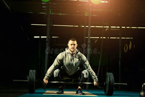 Man With Heavyweight Barbell In The Dark Gym Stock Image Image Of