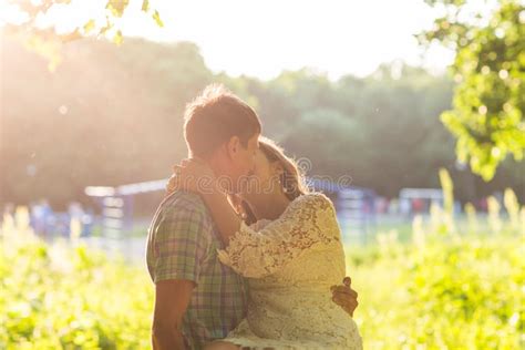 Young Attractive Couple In Love Kissing In Summer In Field Stock Photo