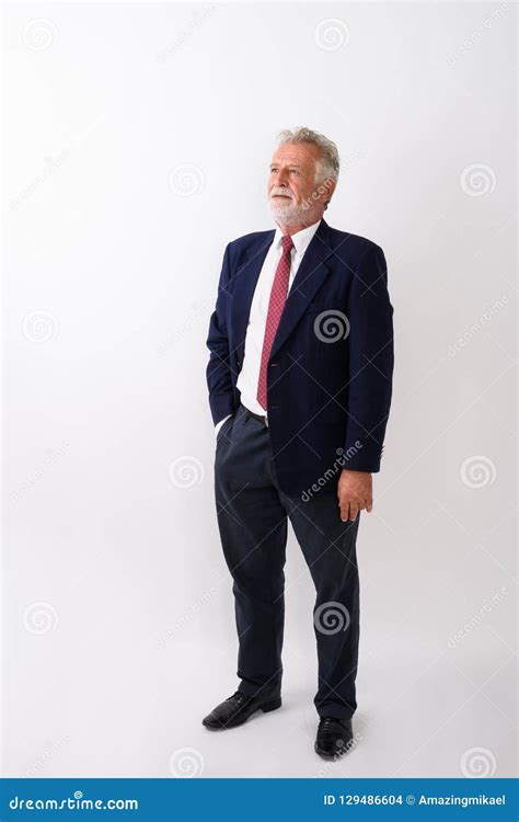 Full Body Shot Of Handsome Senior Bearded Businessman Standing W Stock
