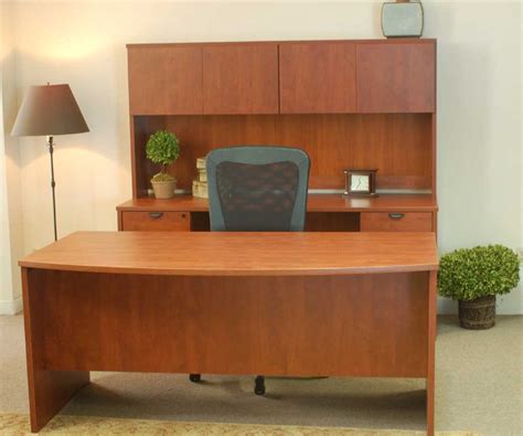 It features an accessory shelf atop a storage cabinet, a keyboard panel equipped with a safety stop, 2 drawers and a file cabinet. Cheap Office Desks for Home and Office