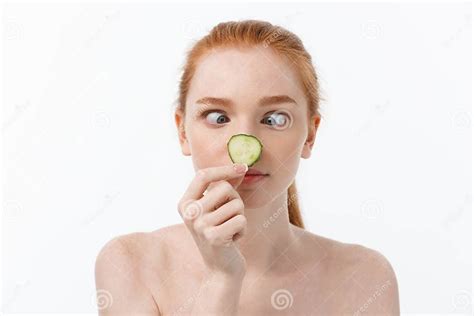 Close Up Beauty Portrait Of A Smiling Beautiful Half Naked Woman Holding Cucumber Slices At Her