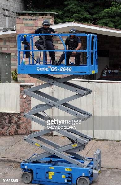 Police Officers Use A Scissor Lift On October 9 2009 To Have A News