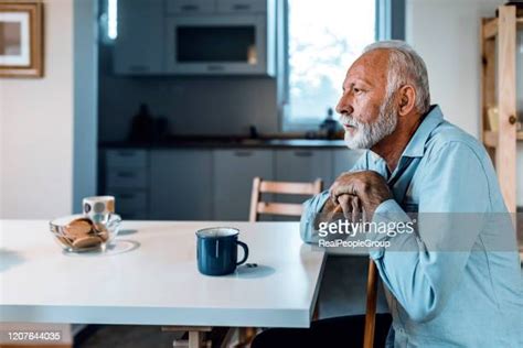 Tired Old Man Sitting In An Armchair Photos And Premium High Res
