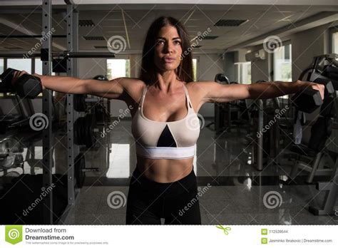 Muscular Woman Exercising Shoulders With Dumbbells Stock Photo Image