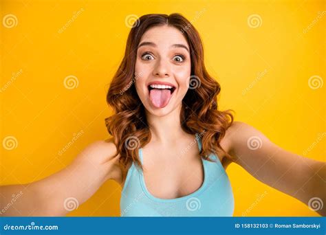 photo of lady making selfies sticking tongue out of mouth wear tank top isolated yellow