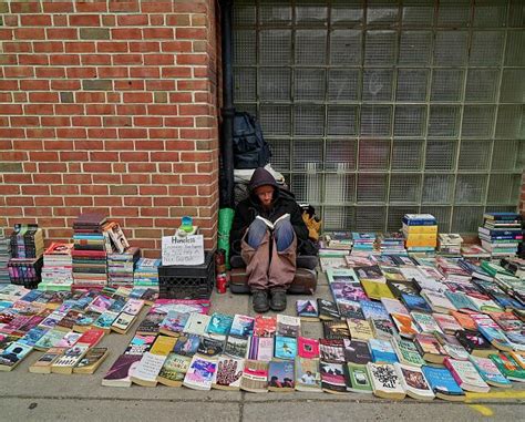 A Homeless Man Josh Jarvis Sits Amid Second Hand Books He Offers For