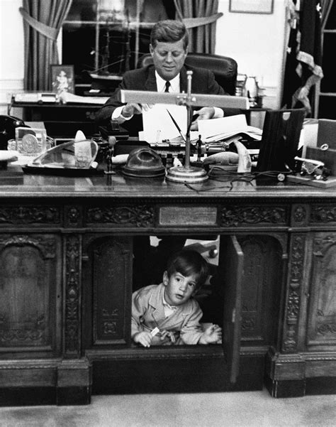 John F Kennedy Jr Exploring His Fathers Desk In The Oval Office On