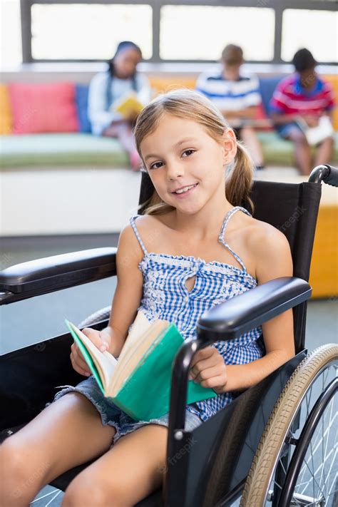 premium photo portrait of disabled school girl reading book in library