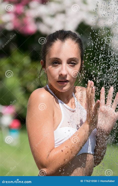 Girl Wear Bikini Standing Under The Outdoor Pool Shower Stock Photo