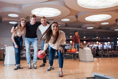 Free Photo Excited People Young Cheerful Friends Have Fun In Bowling