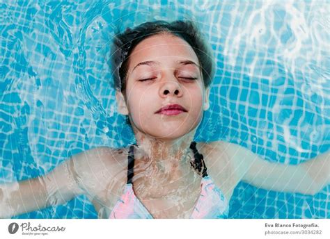 Beautiful Teenager Girl Floating In A Pool Summer Lifestyle A