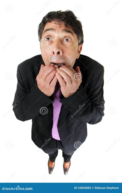 scared businessman full height in desperate pose and giant hand pointing at him royalty free