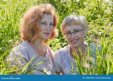 Two Female Friends Having Fun On Nature Chubby And Slim Middle Aged Women Pensioners In A Green