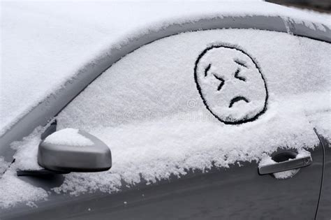 Sad Angry Emoji Face Drawn In Car Window Covered With Snow Stock