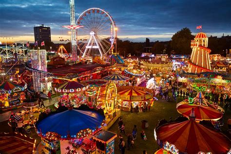An Aerial View Of The Fairground At Night With Carnival Rides And