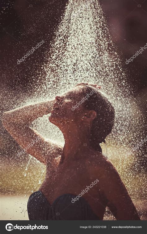 summer vacation and travel sexy woman washing under water or rain drop refreshment and hygiene