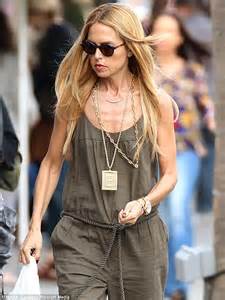 rachel zoe bares her bony chest and rail thin arms in an army green jumpsuit as she visits a