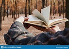 Man Leafing through Open Book in Forest Stock Photo - Image of bacteria ...