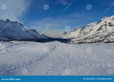 Majestic Tall Snowy Mountain With Vibrant Blue Sky And Fjord Stock