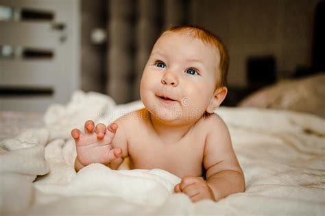 Cute Happy 6 Month Baby Boy In Diaper Lying And Playing Stock Photo