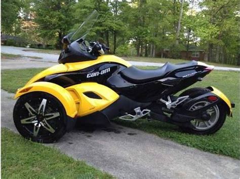 The vehicle has a single rear drive wheel and two wheels in front for steering, similar in layout to a modern snowmobile. 2009 Can-Am Spyder - Roadster Trike - Yellow And Black for ...